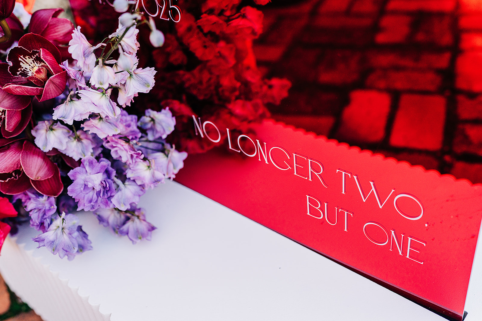 close up of welcome sign that says "no longer two, but one"