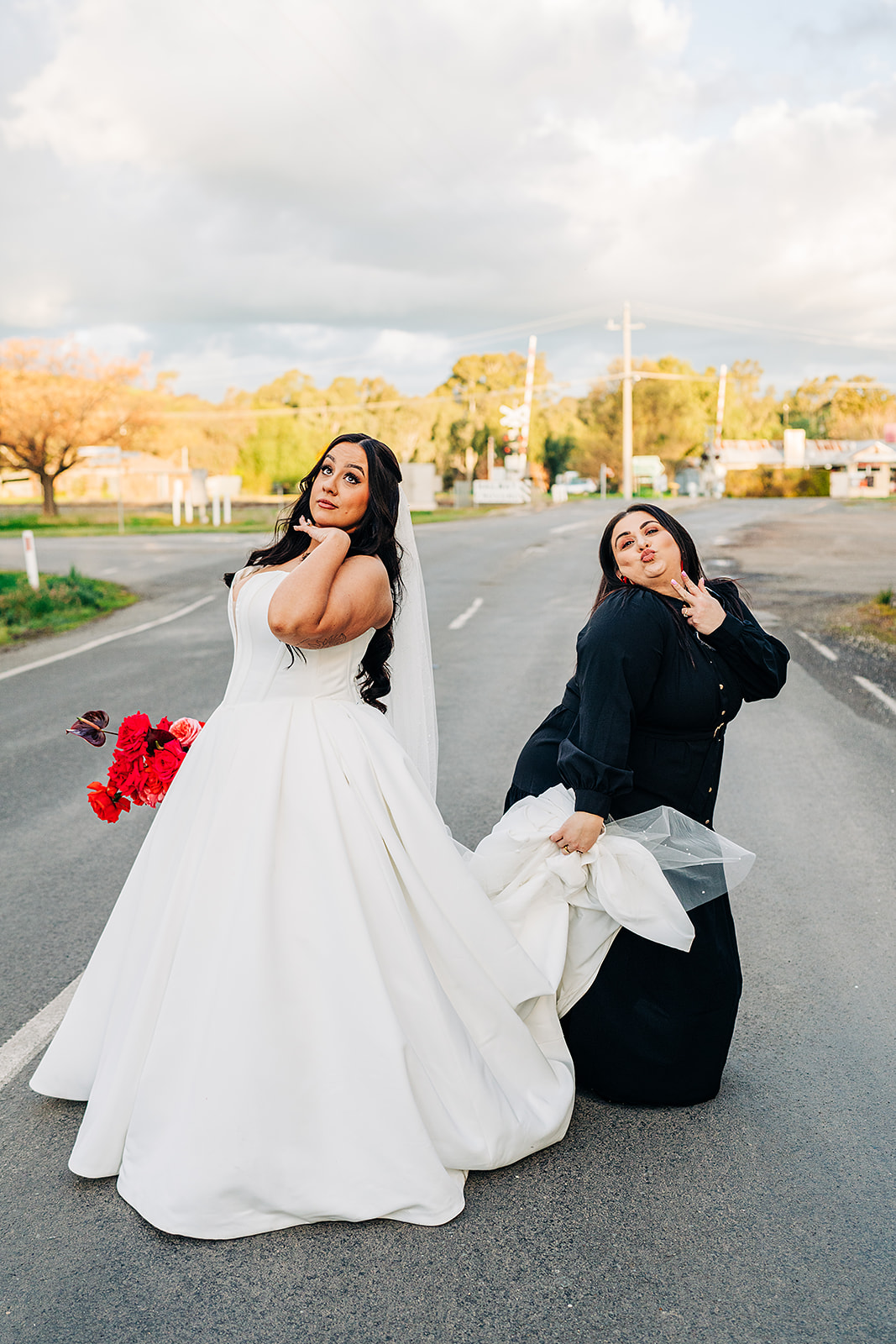 bride and celebrant marry us mich do funny poses outside havest home