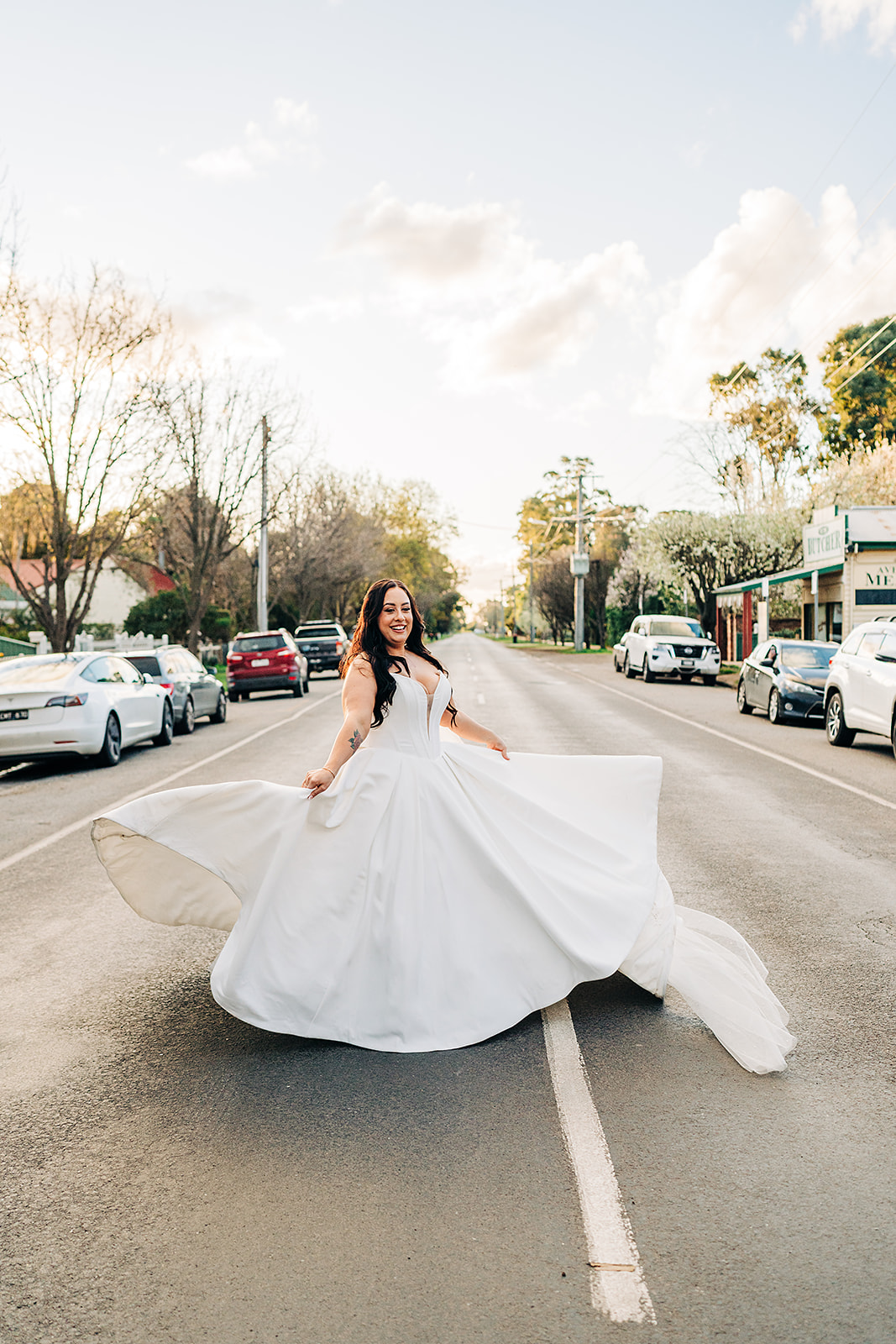 bride doing big spin with dress flowing in all directions outside harvest home