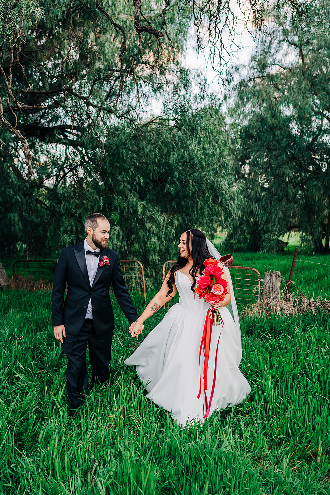couple walking through long grass