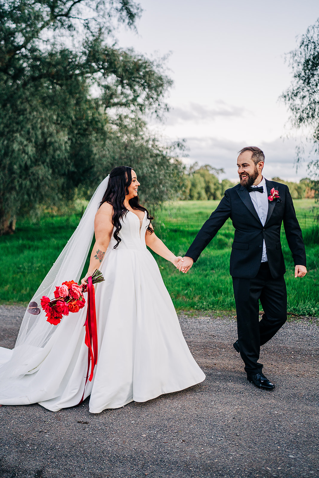 couple walking on dirt road outside harvest home avenel