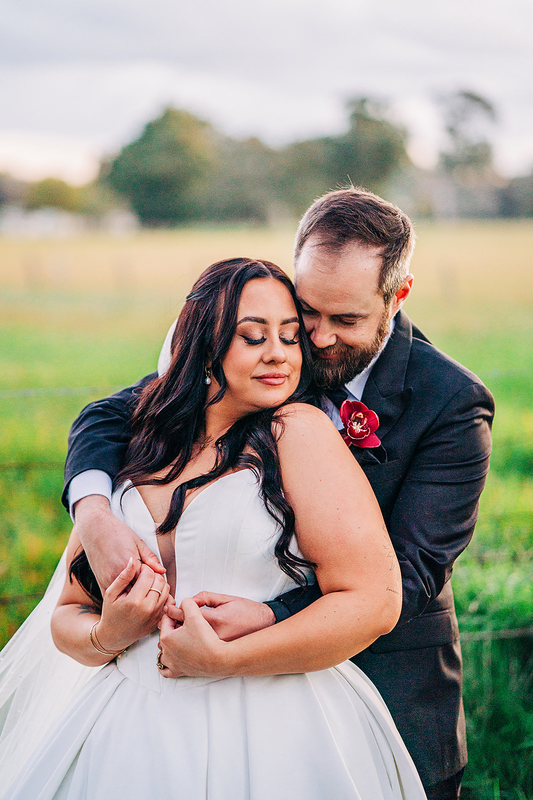 couple cuddle during wedding photos