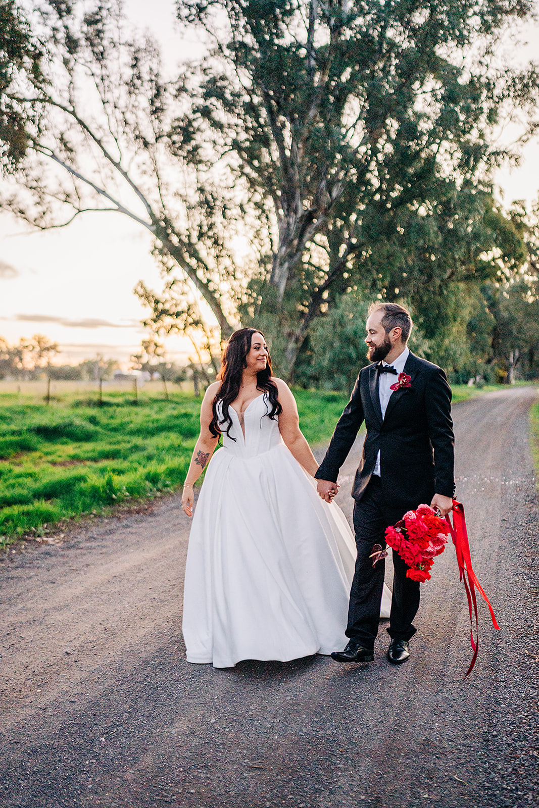 couple walking down dirt road at harvest home avenel