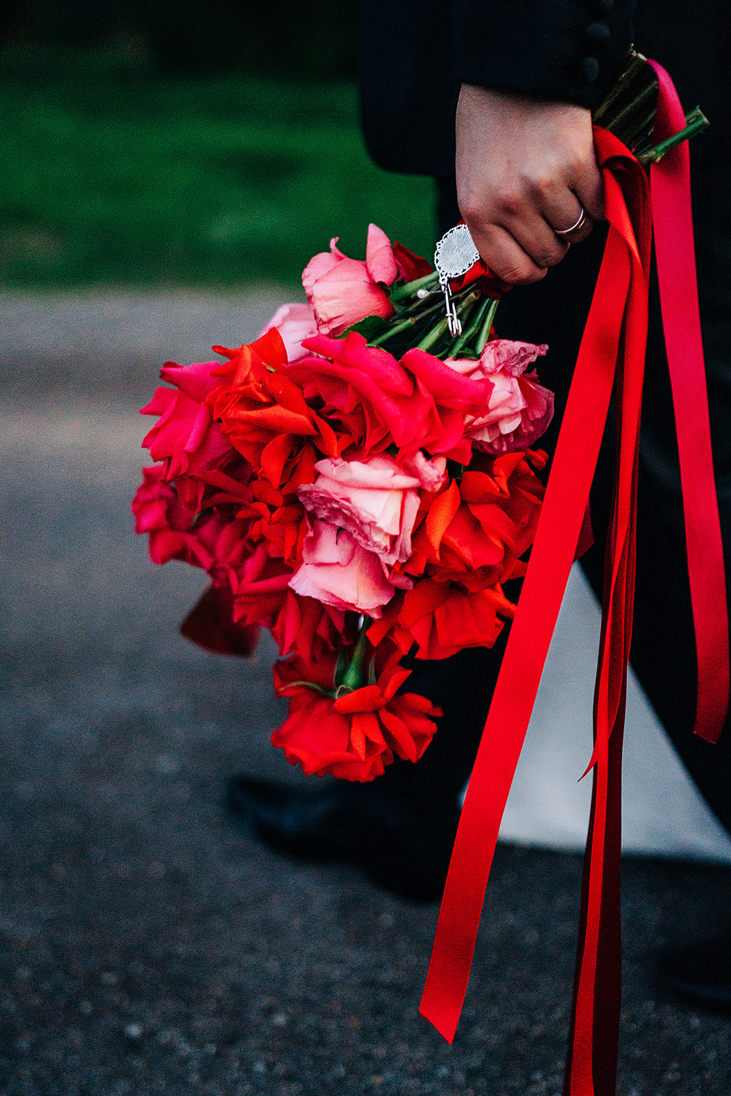 red and pink bouqet with red ribbons