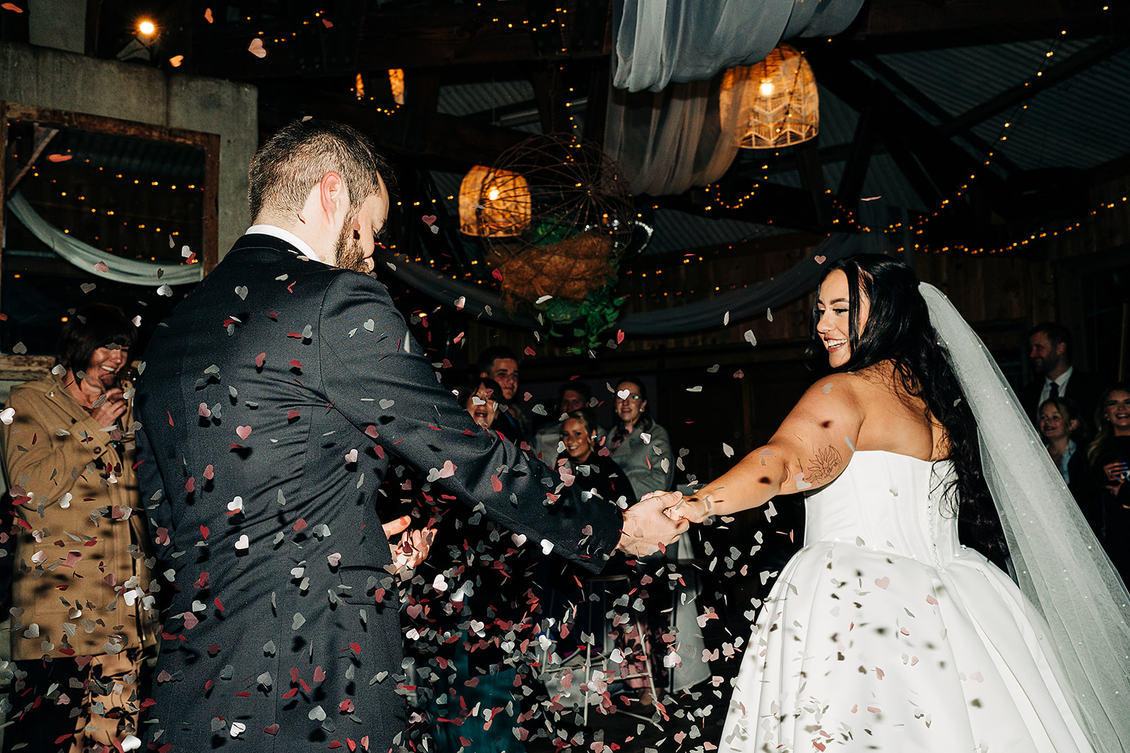 couple entering reception lots of heart shaped confetti