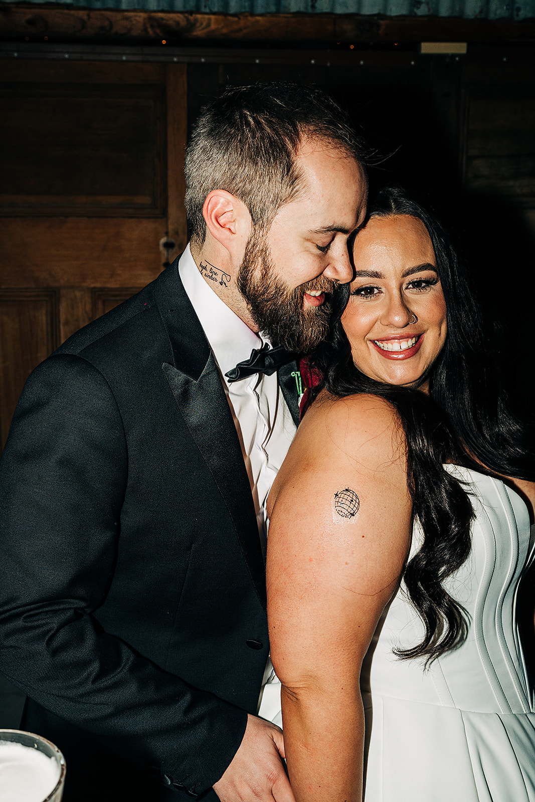 couple whispering after their temporary tattoos