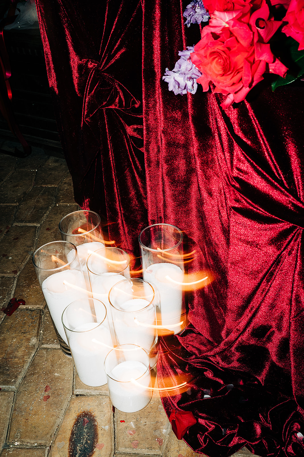 red draping and candles with light streak
