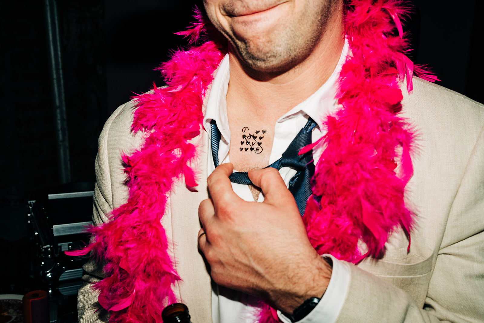 pink boa and a temporary tattoo