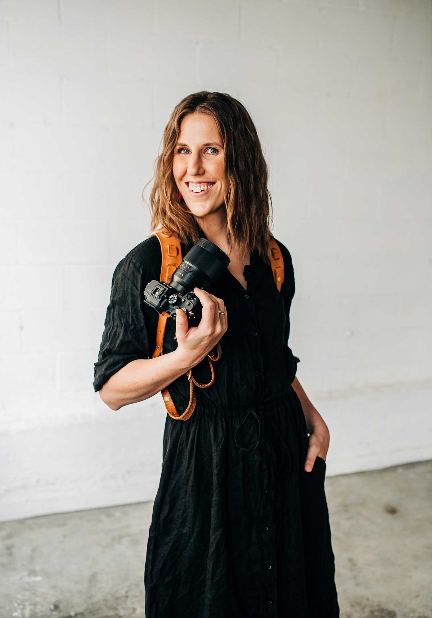 Dani Bartlett posing with her camera.