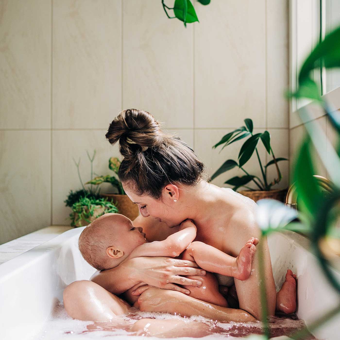 A mother and her baby having family photos taken at home.